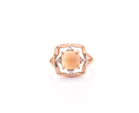 A 9ct yellow gold and opal ring, set with a round cabochon opal, likely Ethiopian, the quatrefoil mount inset with four white