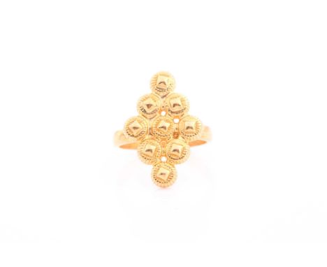 An Indian yellow metal diamond-shaped ring, the mount comprised of nine round segments, size J, unmarked.Condition report: 4.