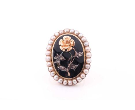 A late 19th century yellow metal, pearl, and black enamel mourning ring, inset with a floral design, the leaves set with rose