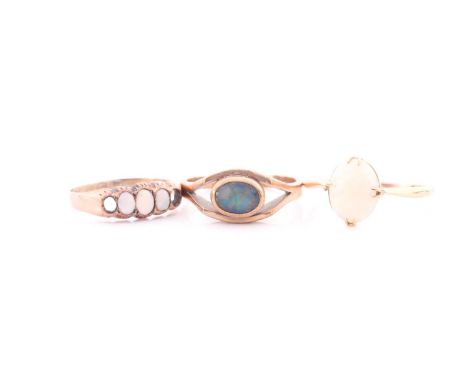 An 18ct yellow gold and opal ring, size R, together with a 9ct yellow gold and triplet opal ring, size Q 1/2, and a late 19th