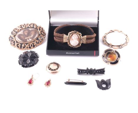 A Victorian woven hair bracelet, fitted with a cameo, together with a gilt meal and enamel mourning brooch inset with curled 