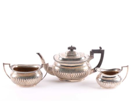 An early 20th century matched three-piece tea set. London 1908 and other dates by Walker &amp; Hall Ltd. With half gadrooned 