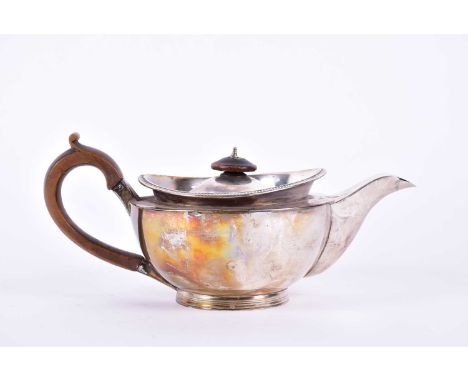 A George III silver teapot. London 1804 by Robert &amp; Samuel Hennell.The compressed urn form with hinged cover, feather gad