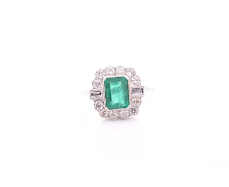 A platinum, diamond, and emerald ring, set with an emerald-cut emerald of approximately 1.60 carats, surrounded with a border