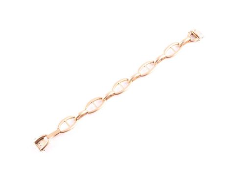 A French yellow metal Hermes style bracelet; of bisected oval loops to a concealed push-button clasp; French poincon marks. 2