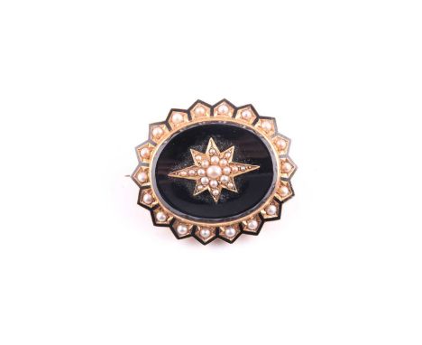 A Victorian yellow metal, pearl, and black enamel mourning brooch, of oval form, with central starburst motif inset with seed