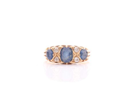 An 18ct yellow gold, diamond, and sapphire ring, set with three sapphires and four small diamonds, size N 1/2.5.5g