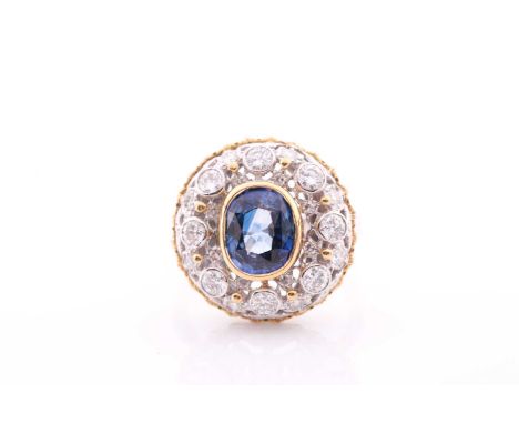 An unusual diamond and sapphire cluster ring, of bombe design, centred with a mixed oval-cut sapphire within a yellow gold co