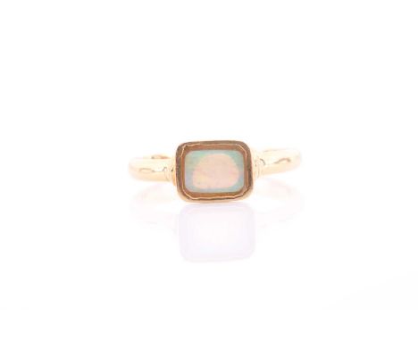 An 18ct yellow gold and opal ring, the rectangular mount inset with an opal plaque, the mount measuring approximately 9.3 x 7