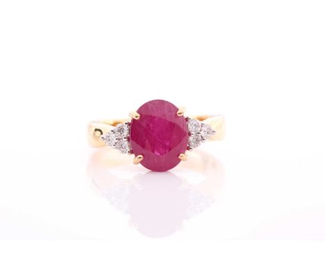 A yellow metal, diamond, and ruby ring, set with a mixed oval-cut ruby flanked with six round-cut diamonds, the ruby measurin