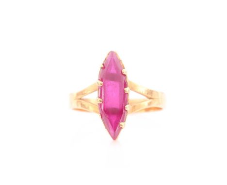 A yellow metal and red paste stone ring, set with a marquise-shaped gemstone, shank unmarked, size L 1/2.Condition report: 3.