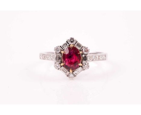 A ruby and diamond cluster ring, the cushion shaped, brilliant step cut ruby in six claw mount, within a border of six round 