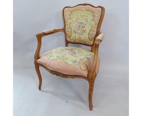 A Continental yew wood tapestry upholstered open armchair, with carved decoration 