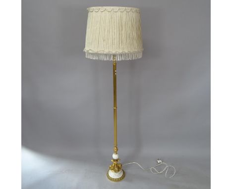 A French Empire style brass standard lamp and shade, with dolphin decoration to base, height overall 171cm 