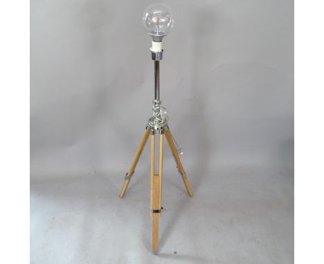 A contemporary telescopic floor lamp on tripod base 