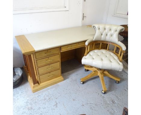 A modern light oak centre-standing kneehole writing desk, with 9 fitted drawers, cupboards on reverse, fitted leather top and