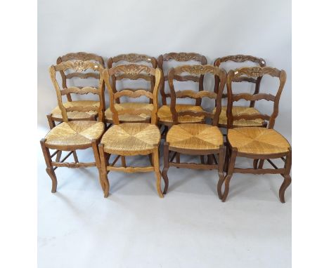 A set of 8 French oak rush-seated ladder-back dining chairs 