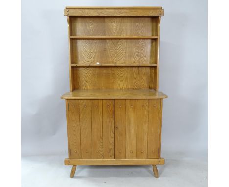 A mid-century brutalist oak dresser by F Co, the plate rack over 2 door cupboard with interior drawer, inset maker’s label to