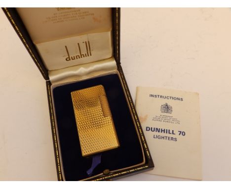 A cased Dunhill 70 gold plated lighter with instruction booklet.