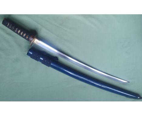 A Japanese wakazashi, the 19" blade with signed tang, in lacquered scabbard.