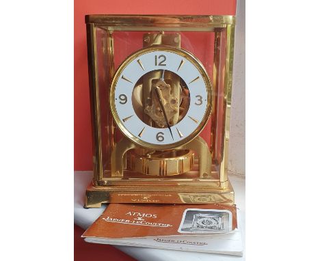 A Jaeger LeCoultre Atmos Classic mantel clock with original instructions, 8.75" high.
