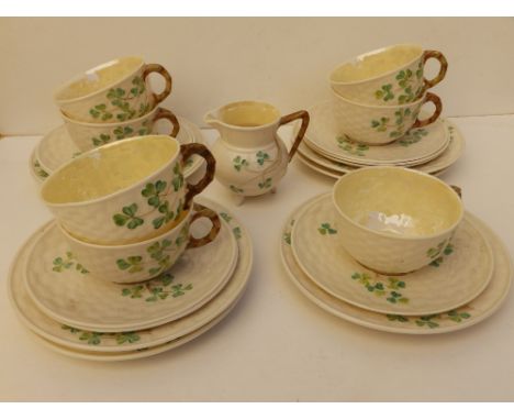 23 pieces of Belleek clover pattern tea china, comprising seven cups &amp; saucers, eight tea plates and a cream jug, black p