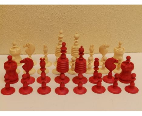 A 19thC red &amp; white stained bone chess set, the kings 4" high. (32)