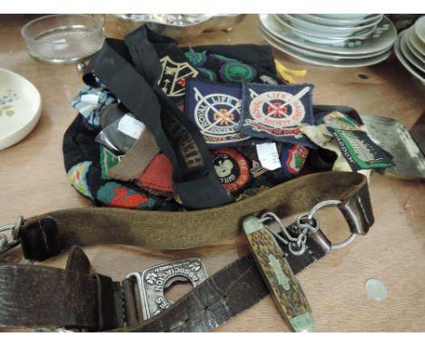 A collection of vintage Girl Guides memorabilia including badges, hat, belt, Scout Knife, etc