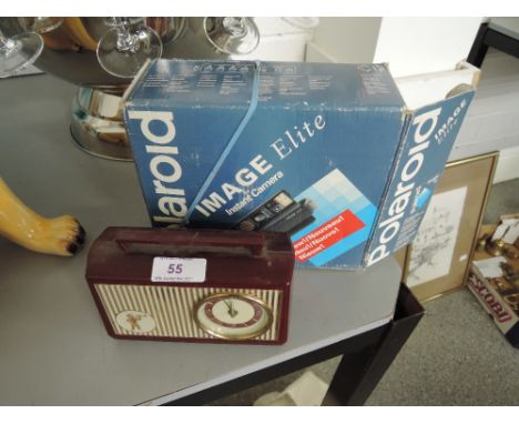 A small bakelite radio and polaroid image elite instant camera