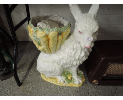 A large ceramic rabbit with bowl on back