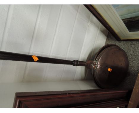 A vintage copper and treen bed warming pan ideal for decor 