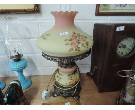 A cast framed table lamp with hand painted glass shade and milk glass chimney