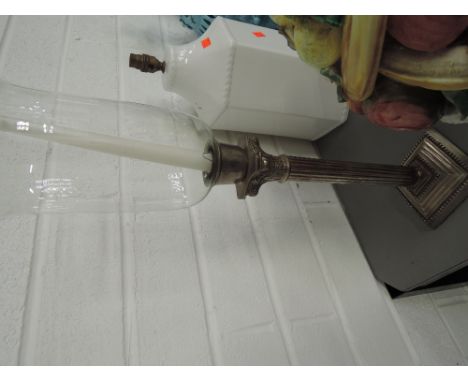 A reproduction Corinthian style candlestick with glass chimney
