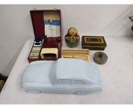 Collectors lot to inc Russian stacking dolls, cash tin, Franc coasters, wooden pens and a ceramic car