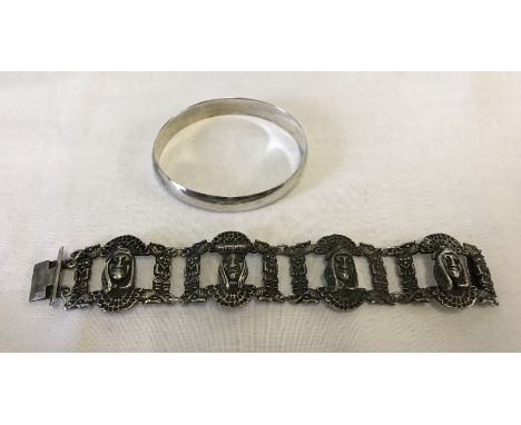 A solid Sterling silver bangle, together with a silver bracelet with Aztec design.  