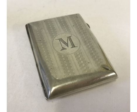 A small silver cigarette case, hallmarked inside with engine turned decoration and M monogram.  