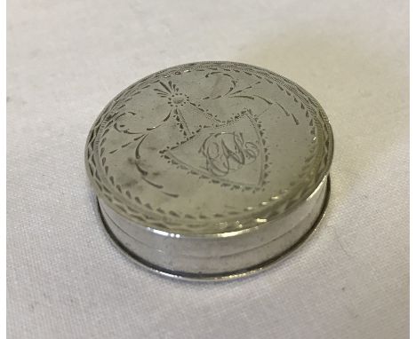 A Georgian silver bright cut round pill box / patch box. Hallmarked to interior. Approx. 3.25cm diameter.