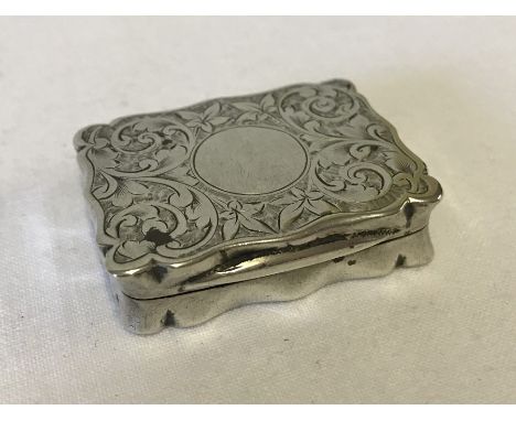 A decorative silver snuff box / stamp box with circular blank cartouche. Engraved detail to top and bottom. Hallmarked Cheste