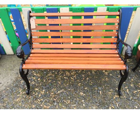 A garden bench with cast iron ends and oak slats.