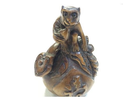 A small carving of a monkey on a giant peach could be classed as a netsuke as has gaps for cord 70 mm.