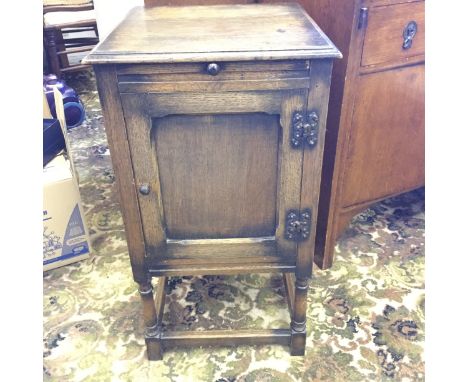 A small bedside cabinet with brushing shelf.