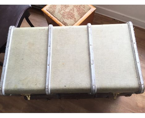A brass and timber bound cabin trunk.$