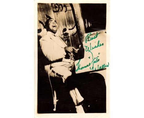 WALLER FATS: (1904-1943) American Jazz Pianist. Vintage signed postcard photograph depicting Waller seated in a full length p