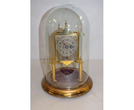 A brass skeleton clock, with engraved arabic silvered dial and a glass dome.