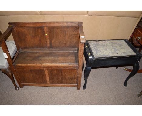 An oak hall bench with hinged seat; together with an ebonised piano stool.