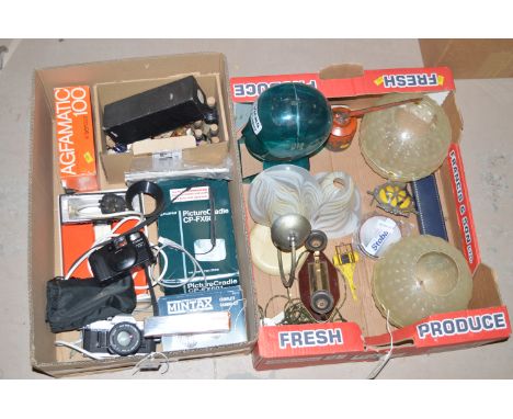 A collection of photographic equipment, including: a Canon LX camera; a Canon AE1; a Mintax 35mm camera; various camera and p