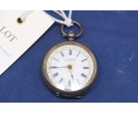 A swiss silver cased fob watch by J.W. Gibbins, stamped 0.935, with white enamel and gilt decoration roman dial.