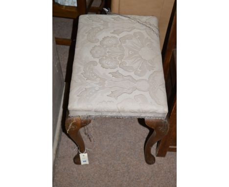 A 20th Century walnut stool, the grey floral patterned material seat raised on cabriole legs.