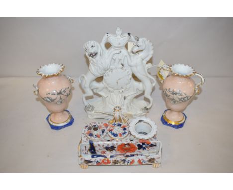 A Staffordshire flatback figure of a clock, with lion and unicorn; a 19th Century inkwell; and a pair of Continental urn-shap