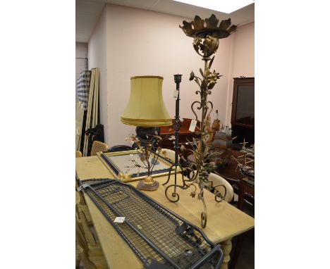 A Subaru car boot grate; a pricket candlestick; a table lamp; a jardiniere; and a gold and ebonised painted mirror.